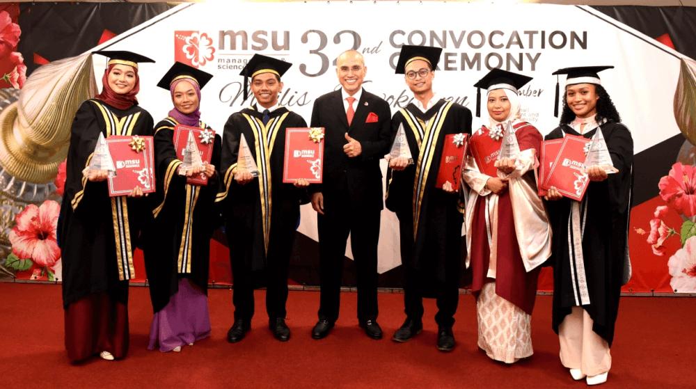 Outstanding graduates in their fields posing with MSU Founder and Vice-Chancellor Professor Tan Sri Dr Mohd Shukri Ab Yajid.