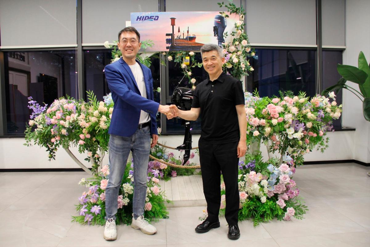 (From left): Tan shakes hands with Zheng after formalising the deal.