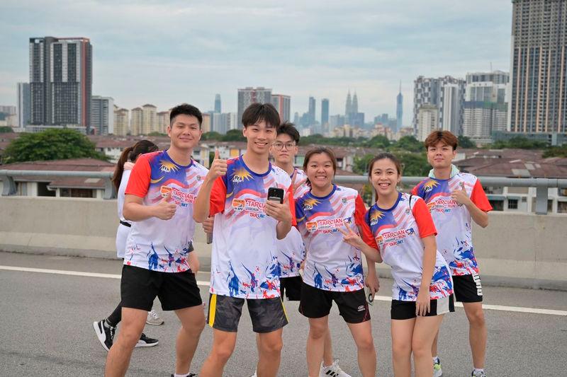 $!Runners posing for shots on the DUKE highway, part of which was closed for the Run