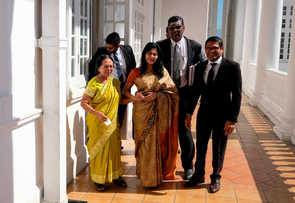 Meeriam Rosaline Edward Paul, 59, (front, center) filed an interim application at the Ipoh High Court in March to obtain unrestricted access to Samy Vellu, apart from a monthly alimony payment of RM25,000. She appeared at the High Court today along with family and legal representatives. - Bernama