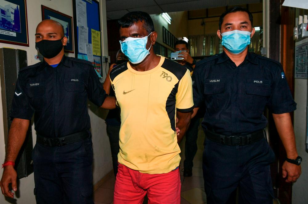 A grass cutter, P. Subramaniam, 48, (middle) charged at the Magistrate’s Court on Jan 15 for obstructing and causing injury to a policeman. Subramaniam pleaded not guilty when the charges were read in front of Magistrate Noor Azreen Liana Mohd Darus. Noor Azreen Liana fixed bail at RM4,000 for both the charges with one surety. The case has been set for February 18 for mention. --fotoBERNAMA (2021) COPYRIGHT RESERVED
