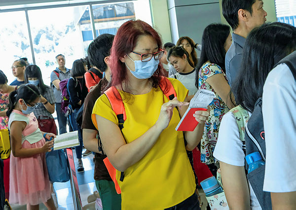 A passenger wearing a face mask arrives at Sultan Azlan Shah Airport in Ipoh yesterday. — Bernama