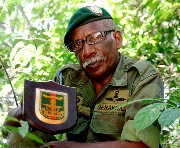 Former commando Paul Karpaya, 67, poses with a plaque he received for serving with the Malaysian Armed Forces, while wearing the green beret he earned through his training. - Bernama
