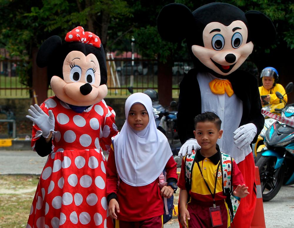 IPOH, 20 March -- Pupils were warmly greeted by Mickey and Minnie Mouse mascots when they attended the first day of the 2023/2024 school session at Sekolah Tasik Damai Kebangsaan today. BERNAMAPIX