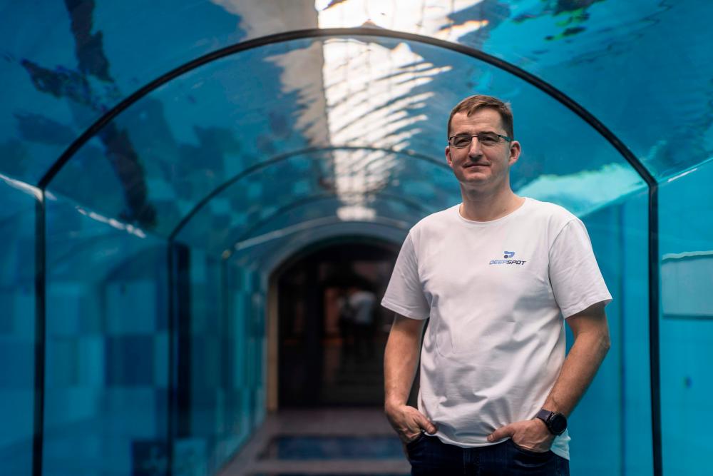 Deepspot director Michal Braszczynski poses at the deepest pool in the world with 45.5-metre (150-foot) located in Mszczonow about 50 km from Warsaw, November 21, 2020. The complex, named Deepspot, even includes a small wreck for scuba and free divers to explore. It has 8,000 cubic metres of water -- more than 20 times the amount in an ordinary 25-metre pool. / AFP / Wojtek RADWANSKI / TO GO WITH AFP STORY