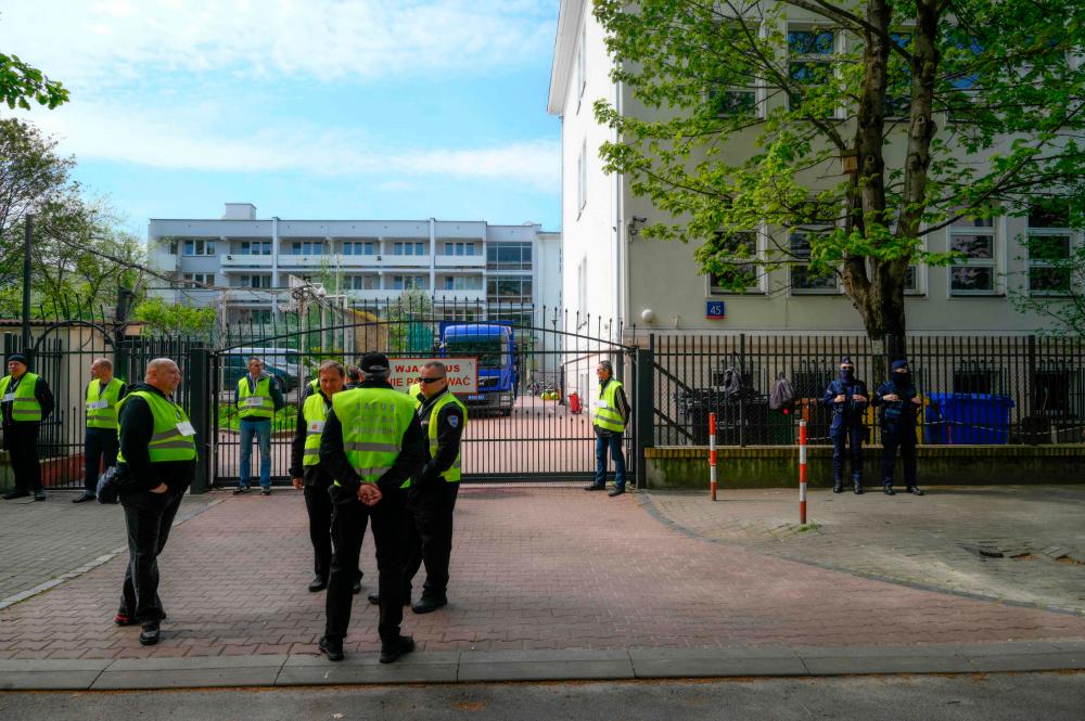 Authorities gather in front a former Russian high school in Warsaw, Poland on 29 April, 2023. Poland on April 29, said it had seized a high school building near Moscow’s embassy in Warsaw meant for the children of diplomats, a move the Russian envoy called “illegal”. AFPPIX