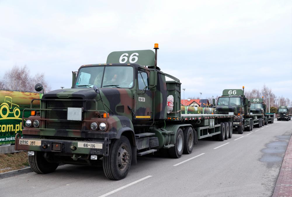 U.S. Military vehicles are parked outside the G2A Arena near the Rzeszow-Jasionka Airport, Poland February 6, 2022. REUTERSpix