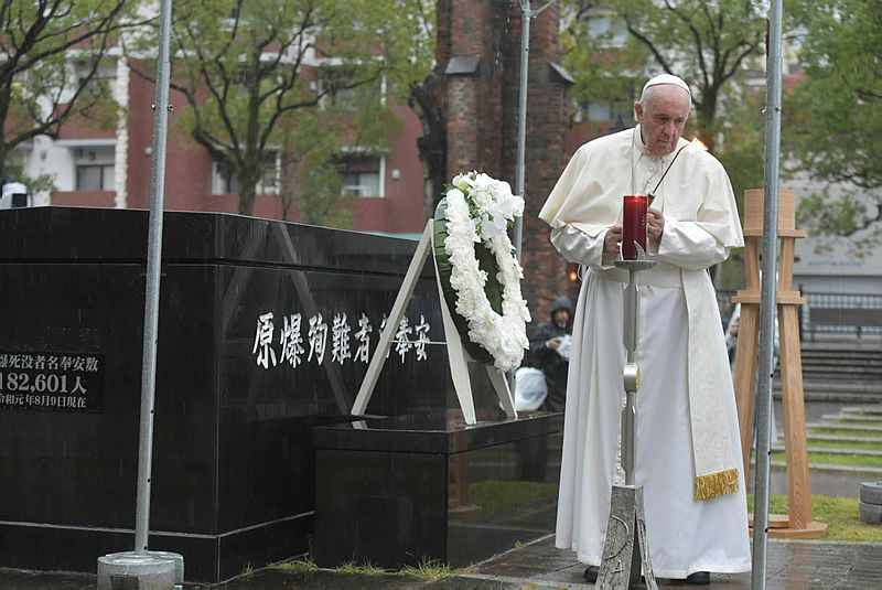 In a handout from Vatican Media and released on Nov 24, 2019 Pope Francis lights a candle at the Atomic Bomb Hypocenter. — AFP