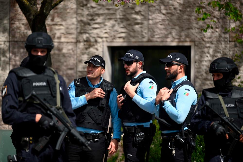 Portuguese police officers stand guard in front of the Ismaili Islamic centre in Lisbon, after two people died following a knife attack that wounded several others, on March 28, 2023. AFPPIX