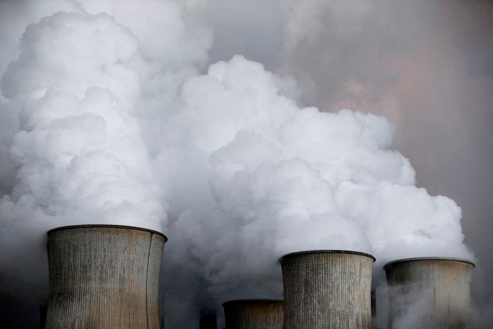 File photo: Steam rises from the cooling towers of the coal power plant of RWE, one of Europe's biggest electricity and gas companies in Niederaussem, Germany, March 3, 2016. REUTERSpix
