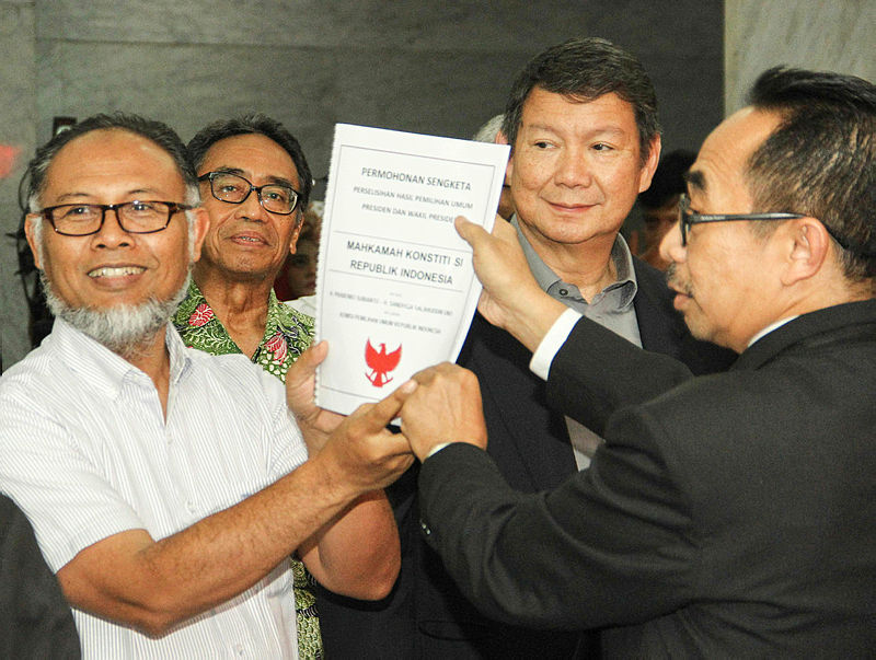 The brother’s of former general and president candidate Prabowo Subianto, Hashim Djojohadikusumo (2nd R), and their lawyer Bambang Widjojanto (L), submit a lawsuit to the constitutional court in Jakarta, on May 24, 2019. — AFP