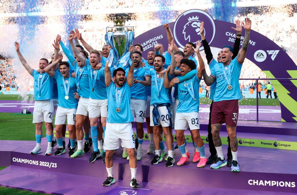 Ilkay Gundogan lifts the trophy as he celebrates with teammates after winning the Premier League/REUTERSPIX
