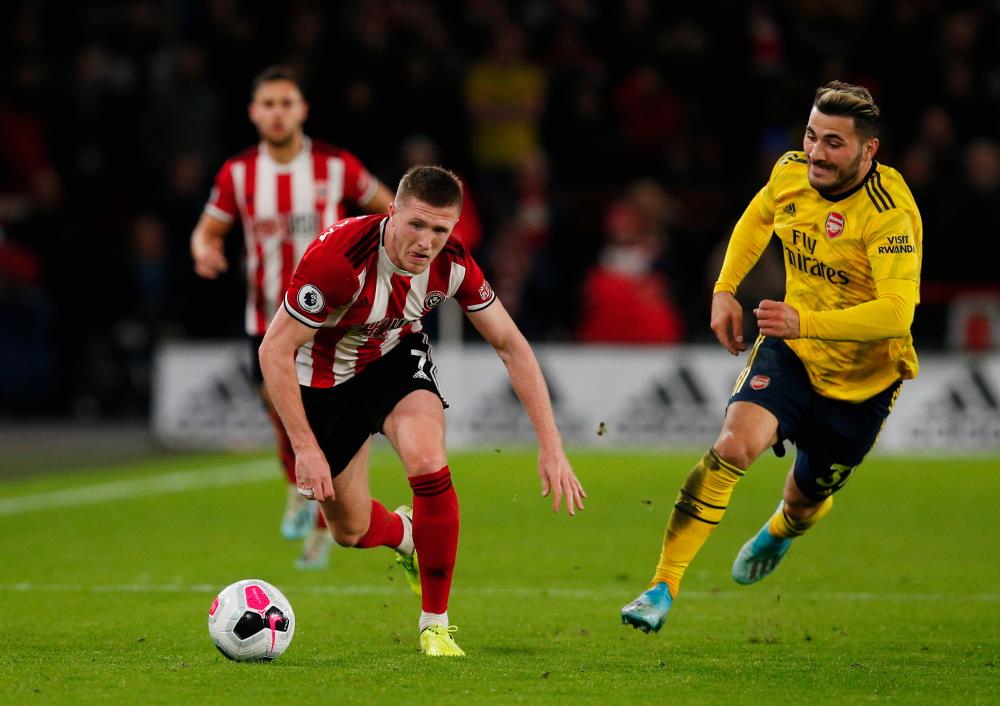 Sheffield United's John Lundstram in action with Arsenal's Sead Kolasinac during the Premier League match between Sheffield United and Arsenal at Bramall Lane, Sheffield, Britain on October 21, 2019. - Reuters