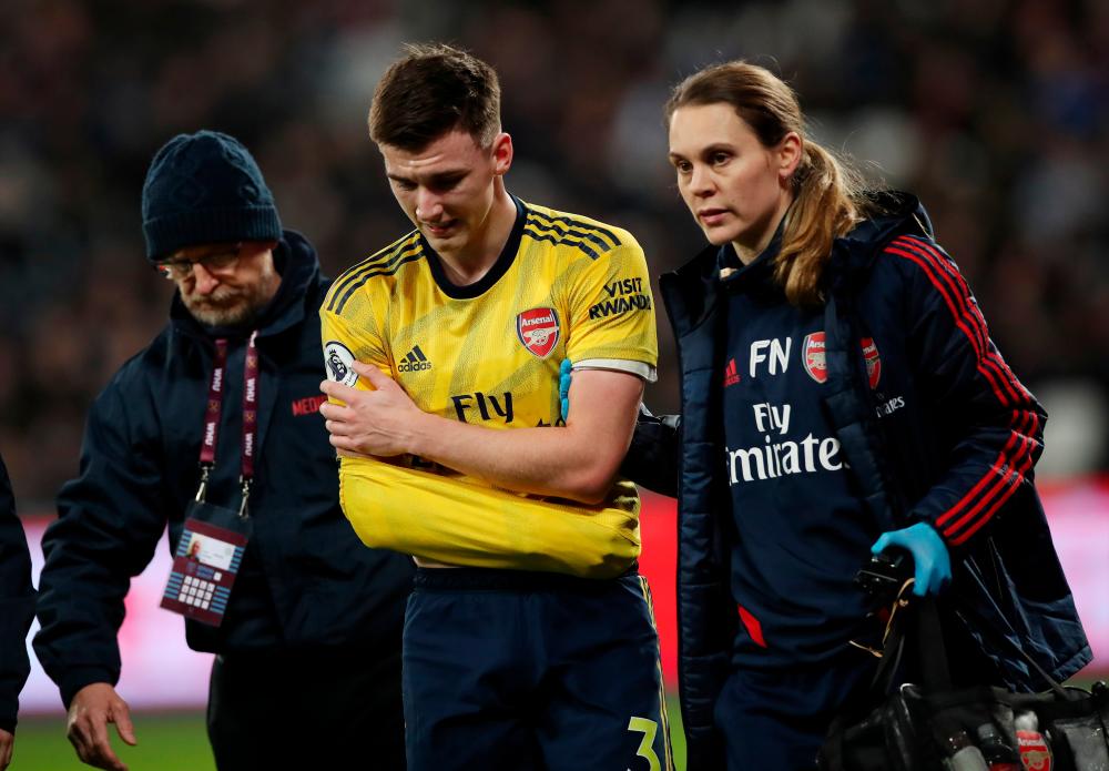 Arsenal's Kieran Tierney is substituted after sustaining a shoulder injury during the Premier League match between West Ham United and Arsenal at London Stadium, London, on December 9, 2019. - Reuters