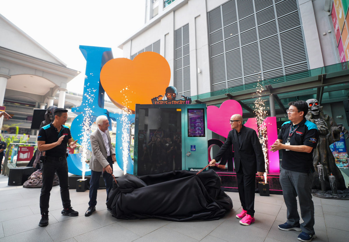 Professor Sibrandes Poppema, President of Sunway University, and Mr. Lynton V. Harris, Founder and Chief Executive Officer of The Sudden Impact Entertainment Company, lead the dramatic reveal of the NOF 11 vending machine, flanked by partners and key guests.