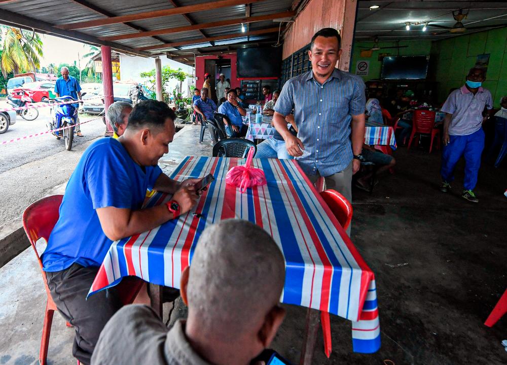 Newly elected representative Mohd Sharim Md Zain meets with locals in Felda Chini 3 today after winning the Chini by-election last night. - Bernama