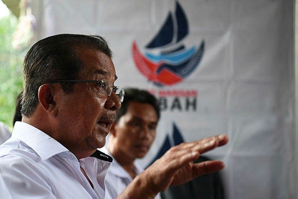 Warisan candidate, Datuk Karim Bujang speaking to reporters after campaigning at Kampung Kelatuan Papar yesterday. — Bernama