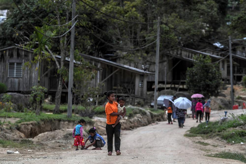 Local residents of Kampung Pos Terisu, Cameron Highlands on Jan 17, 2019 walk along a path unsuitable for vehicles to conduct daily activities. — Bernama