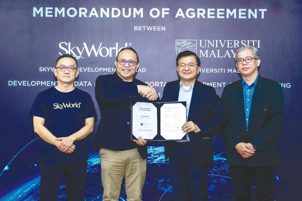 From left: SkyWorld Development Bhd e-Business unit head Wong How Kui, Lee, Loo, and University Malaya UM Consult director Professor Dr Yap Hwa Jen.