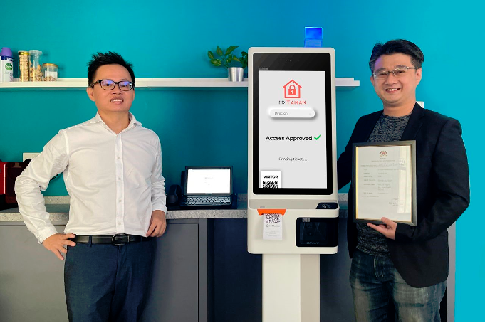 Lim (left) and MyTaman CTO &amp; co-founder Eric Ong with the visitor self-service kiosk.