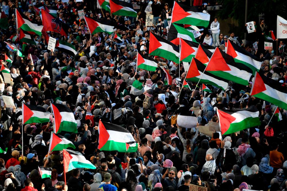 Protesters wave Palestinian flags during a demonstration against Israel at the Town Hall in Sydney on May 15, 2021, amid the ongoing conflict between Israel and the Palestinian Territories. — AFP