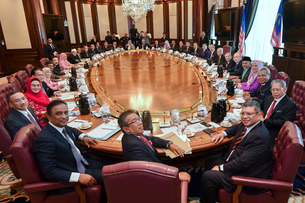 Prime Minister Tan Sri Muhyiddin Yassin poses with a cabinet ministers before the first new cabinet meeting at the Perdana Putra today. — Bernama