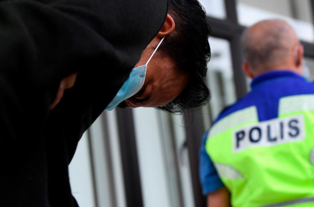 Mohd Hairil Izzuan A Samad, 41, was charged in the Magistrate’s Court here today with murdering his wife, whose body was found dead in a car last July 30. — Bernama