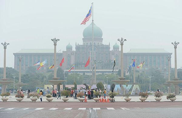 A view of Putrajaya at noon today shows the haze surrounding the area. — Bernama