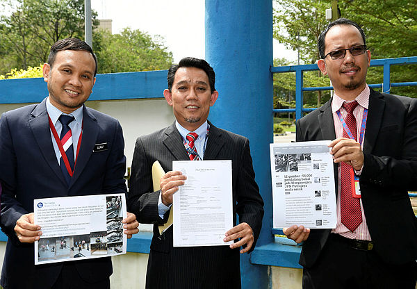 NRD deputy director-general (Operations) Jasri Kasim (centre) presenting the police report that was lodged today at the Putrajaya Police headquarters.