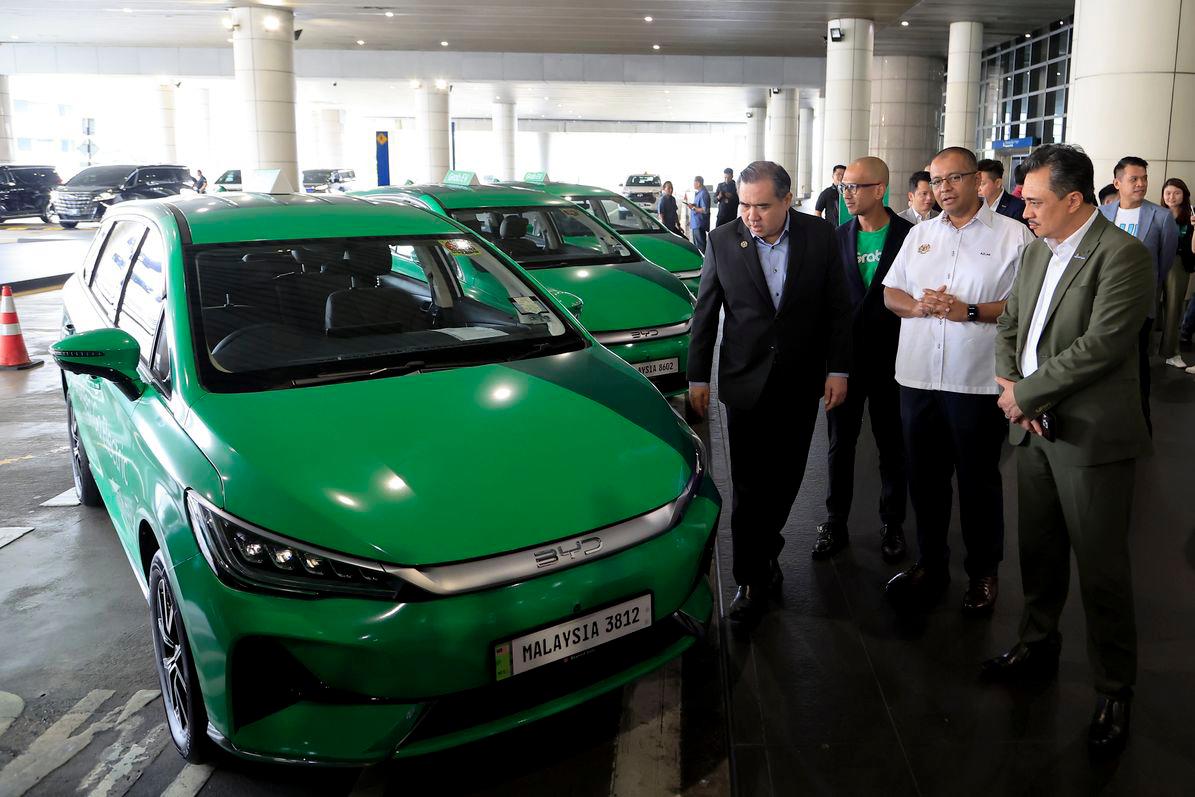 Menteri Pengangkutan Anthony Loke melihat kenderaan elektrik (EV) jenis BYD pada Majlis Perasmian Perkhidmatan Grab EV di Lapangan Terbang Antarabangsa Kuala Lumpur (KLIA) hari ini. - fotoBERNAMA
