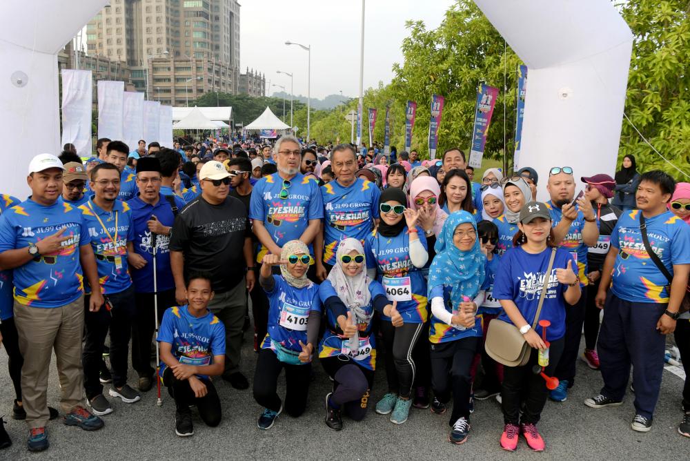 Health Minister Datuk Seri Dr Dzulkefly Ahmad (C) with Federal Territories Minister Khalid Abdul Samad pose for a picture with the participants of Eyeshade Walk &amp; Run 2019 run by the Malaysian Blind Foundation at the Ministry of Tourism, Arts and Culture Grounds, on April 20, 2019. — Bernama