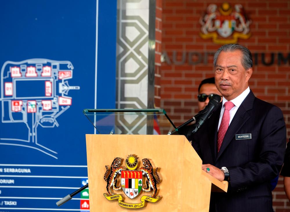 Home Minister Tan Sri Muhyiddin Yassin speaks during the flagging-off the East Coast Post-Disaster Humanitarian Mission convoy in Putrajaya today. - Bernama