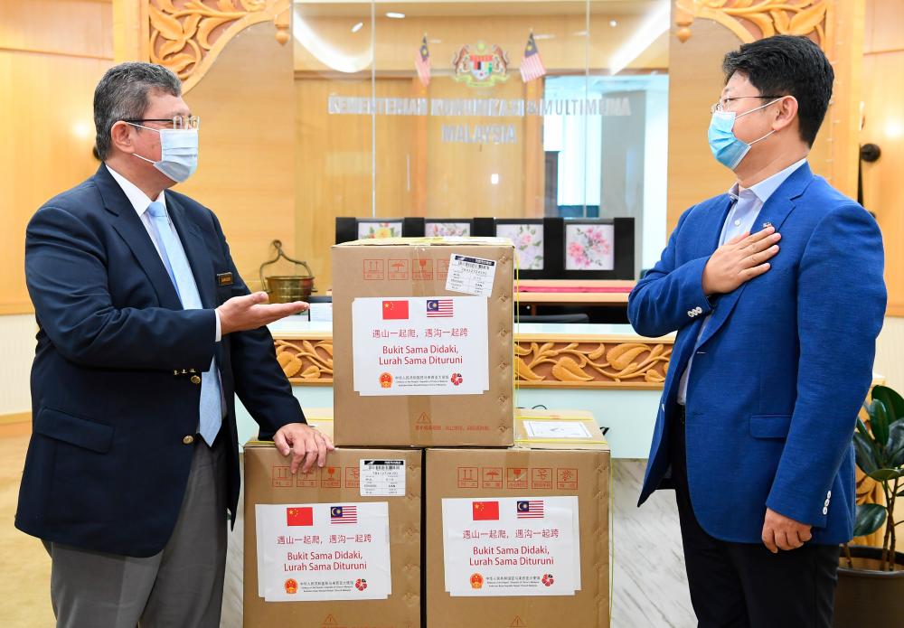 Communications and Multimedia Datuk Minister Saifuddin Abdullah (L) receives a donation of 10,000 face masks from Chinese Ambassador to Malaysia Bai Tian today. - Bernama