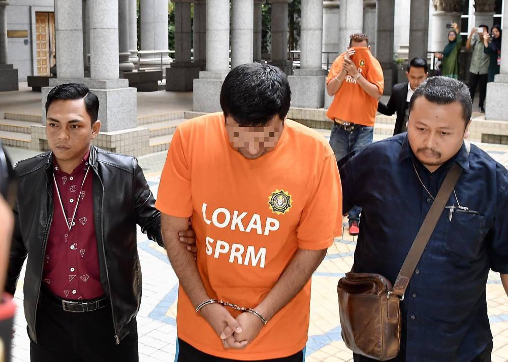 A deputy director of a government agency and a private sector employee are in remand for four days from today for investigation on a corruption case involving RM270,000 relating to a project under the Universal Service Provision (USP) programme on, Jan 10, 2019. — Bernama