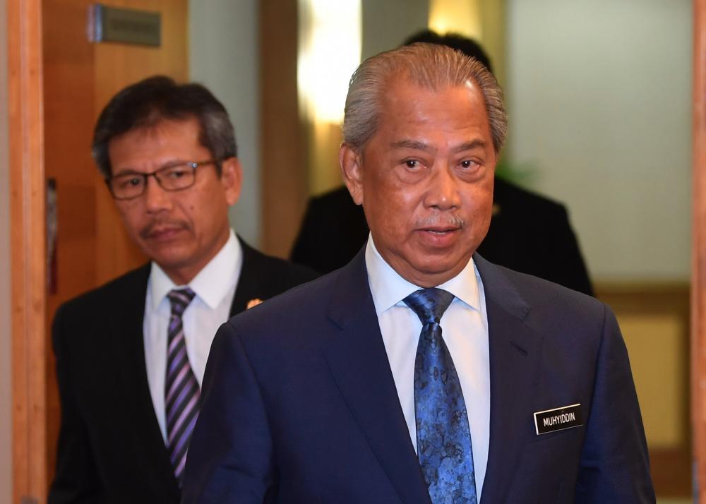 Home Minister Tan Sri Muhyiddin Yassin (R) is accompanied by Home Ministry Secretary-General Datuk Seri Alwi Ibrahim during a press conference on May 2, 2019. - Bernama