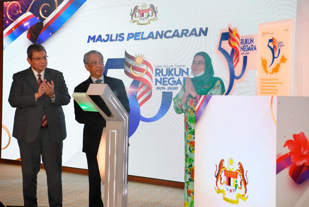 Prime Minister Tan Sri Muhyiddin Yassin (C) at the launch of Rukun Negara Golden Jubilee, as Minister of Communications and Multimedia Datuk Saifuddin Abdullah (L), Minister of National Unity Datuk Halimah Mohamed Sadique (R) look on, on July 9, 2020. — Bernama