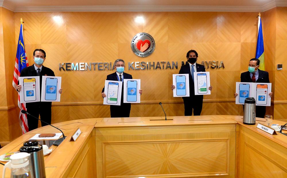 Health Minister Datuk Seri Dr Adham Baba (2nd from L) with Science, Technology and Innovation Minister Khairy Jamaluddin (2nd from R) at the soft launch of the MySejahtera app at the Ministry of Health today. - Bernama