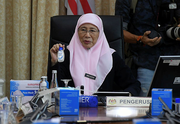 Deputy Prime Minister Datuk Seri Dr Azizah Wan Ismail presenting hand sanitisers before chairing a meeting on the coronovirus outbreak at Perdana Putra today. — Bernama