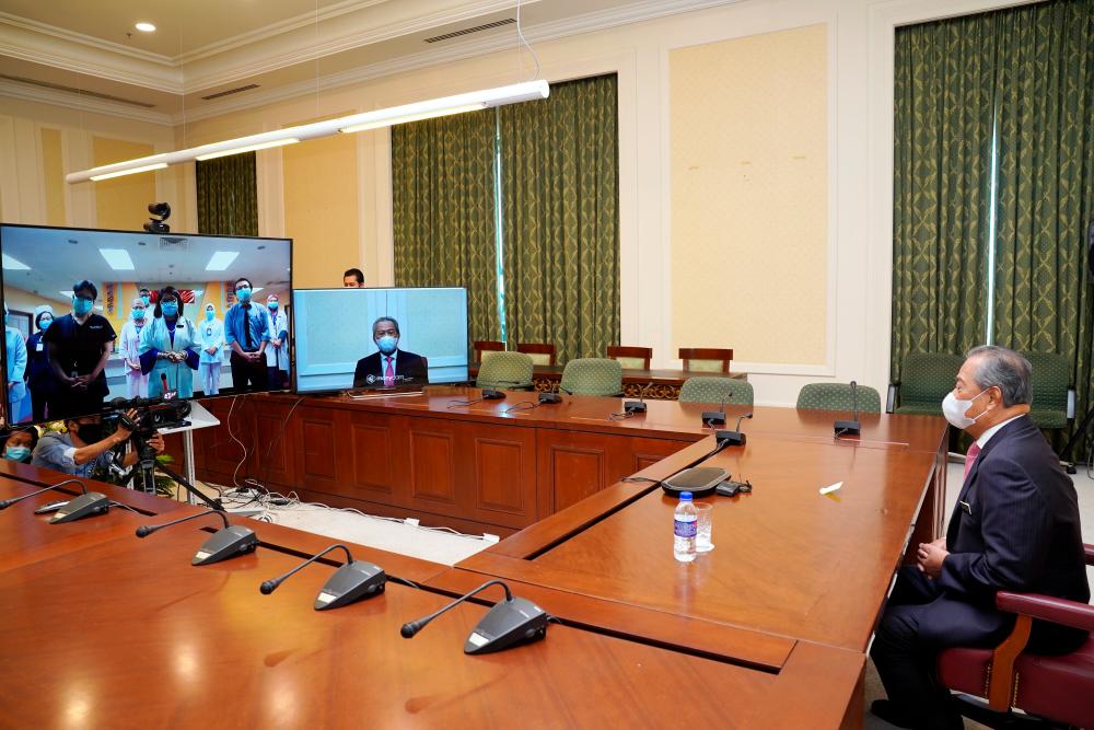 Prime Minister Tan Sri Muhyiddin Yassin during a video conference with medical staff of the Sungai Buloh Hospital at the Perdana Putra today.  - Bernama