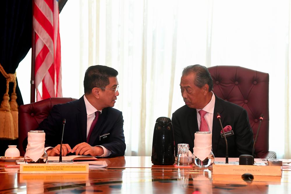 Prime Minister Tan Sri Muhyiddin Yassin (R) chairing the first new cabinet meeting at the Perdana Putra today.Also present Senior Minister-International Trade and Industry Minister Datuk Seri Mohamed Azmin Ali (L). — Bernama