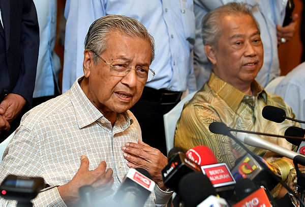 Prime Minister Tun Dr Mahathir Mohamad speaks to the media, while seated alongside Home Minister Tan Sri Muhyiddin Yassin, during a press conference after chairing the PH presidential council meeting in Putrajaya on Feb 1, 2019. — Bernama