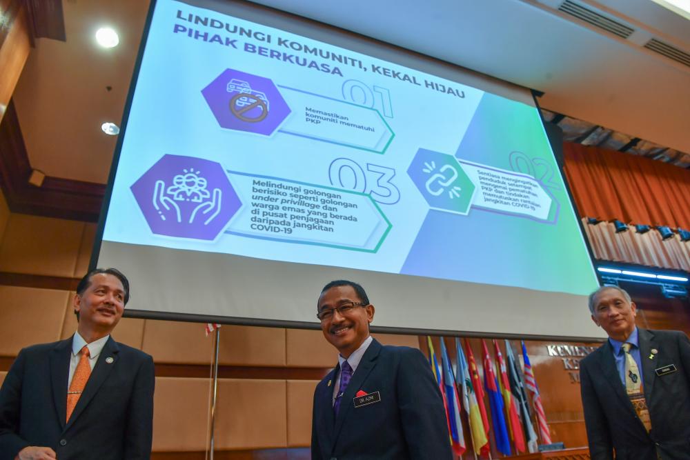 Deputy Health Minister Datuk Dr Noor Azmi Ghazali (C) with Health director-general Datuk Dr Noor Hisham Abdullah and deputy director-general of Health (Public Health) Dr Chong Chee Kheong (R) during the launch of the Covid-19 Infectious Disease Reduction Programme at the Ministry of Health today. - Bernama