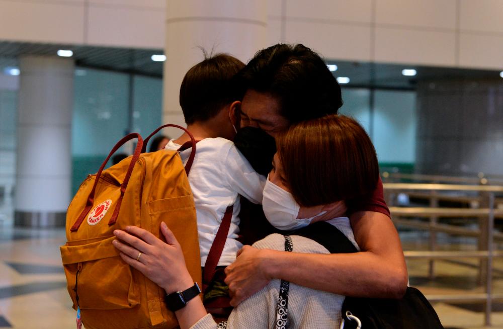 SEPANG, April 1 - A father hugged his son and wife tightly upon arriving at the Kuala Lumpur International Airport (KLIA) today, after seven months of not meeting. BERNAMAPIX