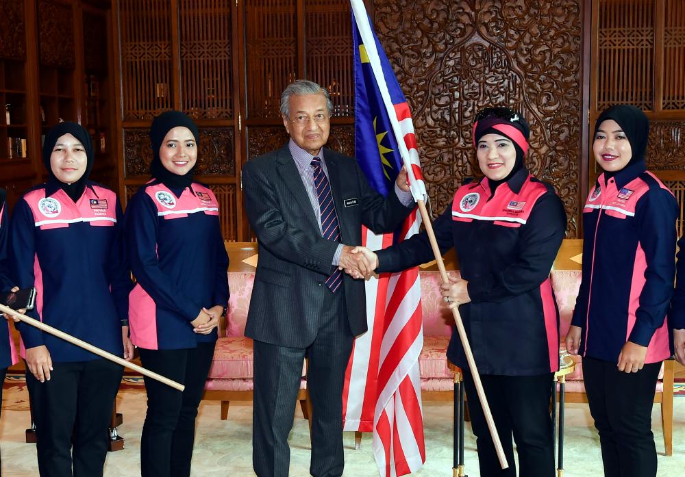 Prime Minister Tun Dr Mahathir Mohamad hands over the Malaysian flag to participants of the All Women Expedition to Antarctica, led by their mentor, Dr Sharifah Mazlina Syed Abdul Kadir (2nd from R) at the Perdana Putra today. - Bernama