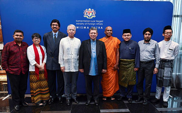 Foreign Minister Datuk Saifuddin Abdullah middle poses for a photograph alongside members of the Friendship Group of Inter-Religious Services (FGIS) during the farewell ceremony of Holy See Ambassador to Malaysia Joseph Marino (fourth from the left) in Wisma Putra — Bernama
