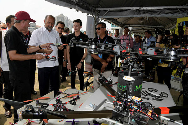 Communications and Multimedia Minister Gobind Singh Deo (2nd from L) visits the exhibition hall of the Parcel Drone Competition 2019 at the Putrajaya Water Sports Complex, on March 7, 2019. — Bernama