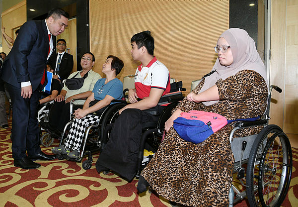 Transport Minister Anthony Loke greeting with drivers with special needs (OKU) at the Public Service Vehicle (PSV) licensing test today in Putrajaya.