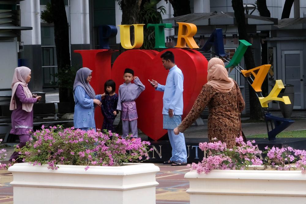 A family clad in Raya outfit poses for a photograph in Putrajaya, on May 25, 2020. — Bernama
