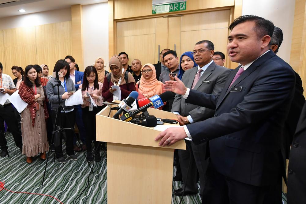 Transport Minister Anthony Loke Siew Fook (R) gives a press conference after chairing the Transport Ministry’s post-cabinet meeting today. - Bernama