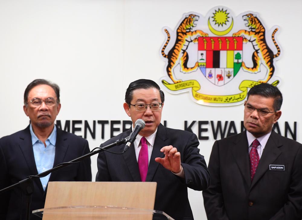 Finance Minister Lim Guan Eng (c) responds to questions from the media at the Ministry of Finance on June 25, 2019. - Bernama